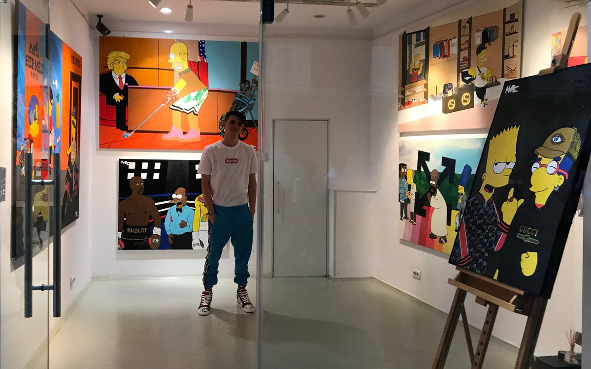 Marc in a gallery, surrounded by his paintings